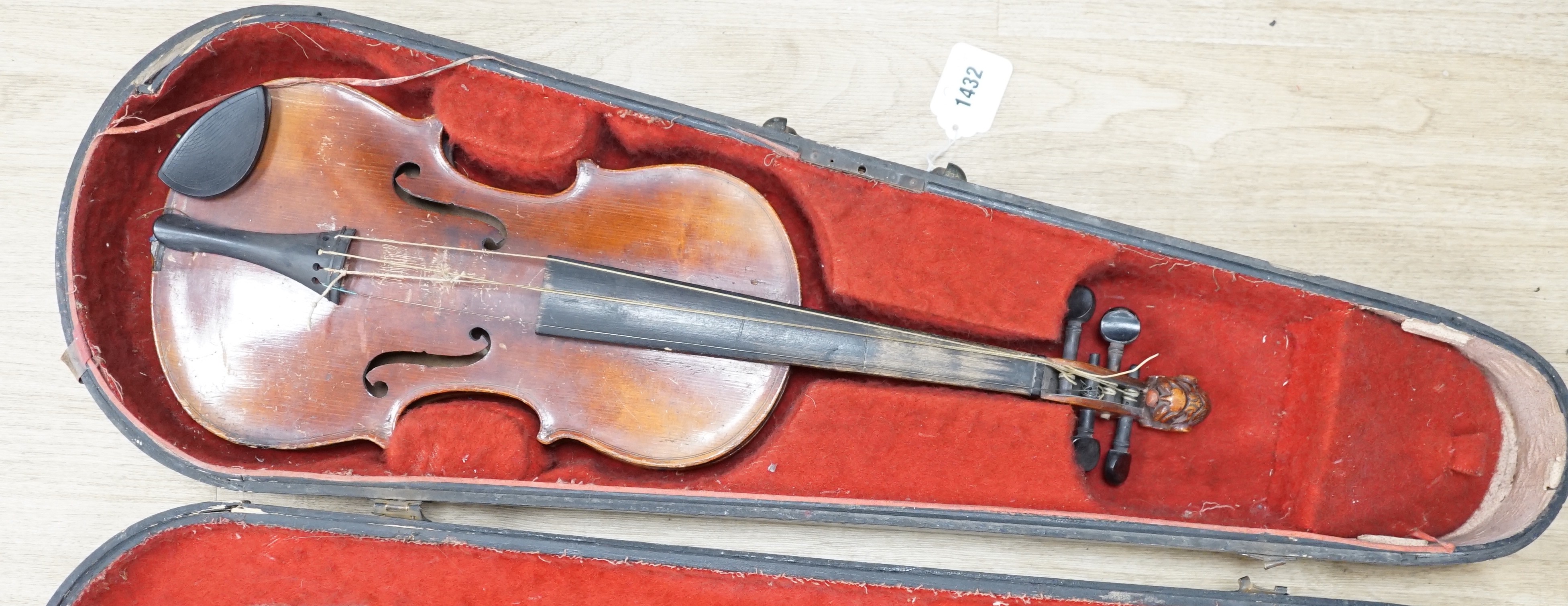 A late 19th century lion head violin and case